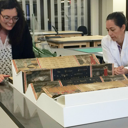 Sarah Reidell, the Margy Meyerson Head of Conservation (left), and Susan Bing, a conservation staff member, discuss the best ways to conserve and display a large manuscript
