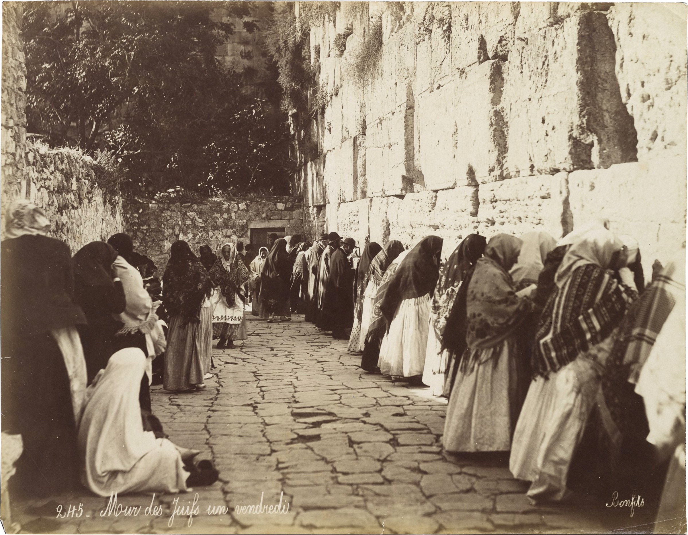 Photograph by Felix Bonfils showing men and women at the Wall