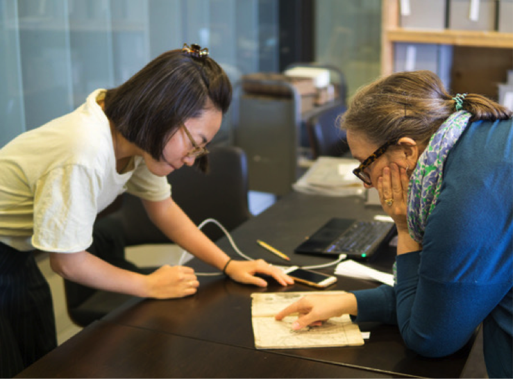 Professor Davis (right) and Naoko Adachi, doctoral candidate in East Asia Study at Penn, review a book from the Tress Collection.