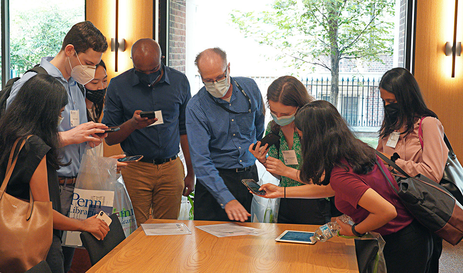 A librarian shows documents to a group of students around a table