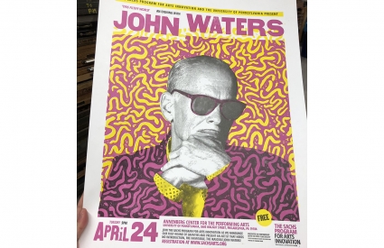 Brightly colored poster with image of John Waters at center