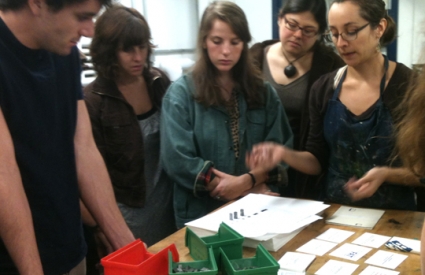 Students around a table of prints