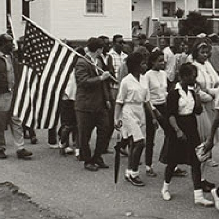 Black and white photograph of marching protestors