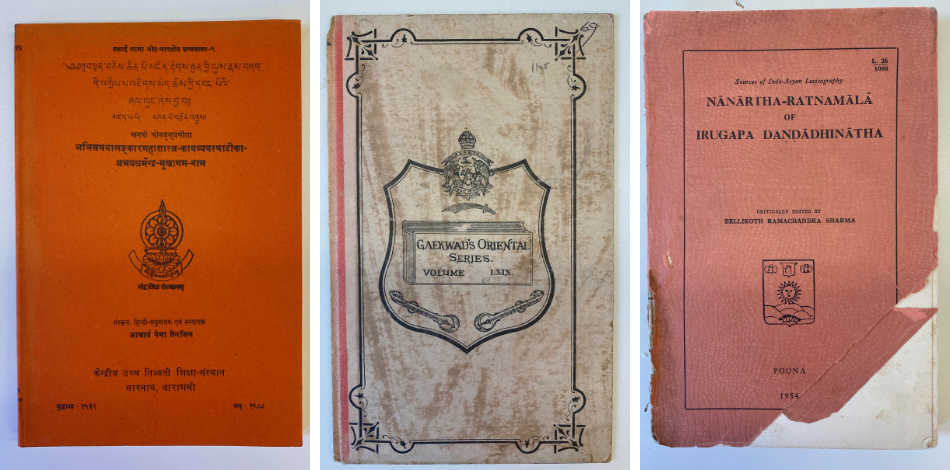 Three books with orange and grey covers with titles written in Sanskrit