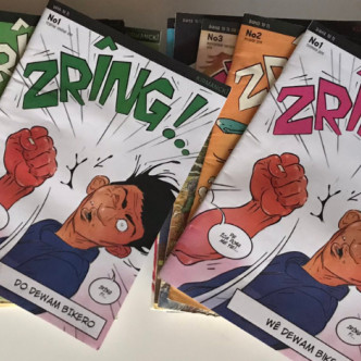 A stack of issues of the comic book 'Zring!' showing a colorful cartoon of a person getting punched in the face