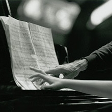 Hands of pianist Rieko Aizawa and cellist Paul Tortelier at the piano, 1992. 
