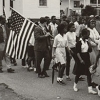 Black and white photograph of marching protestors