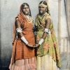 Old postcard with hand colored photographs of women in Trinidadian dress