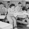 Photo of people working at tables in classroom